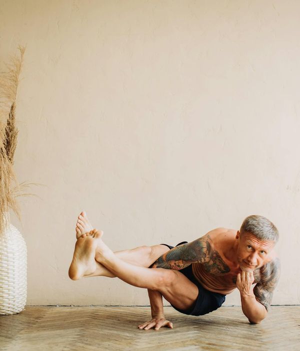 Man performing a slow, controlled strength exercise in a calm setting.